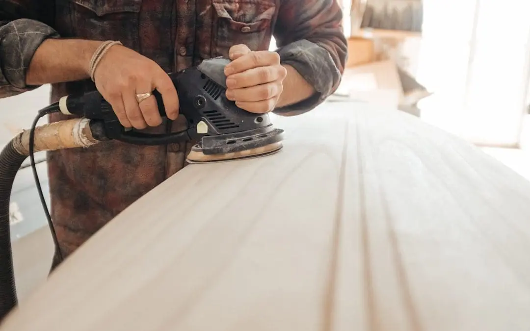 technician sanding wood cabinets